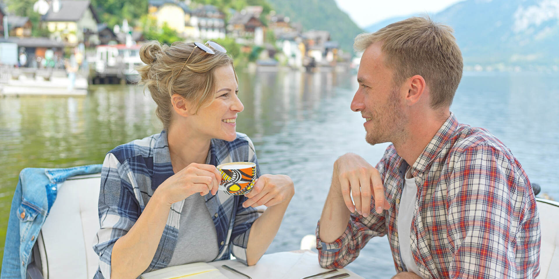 Hallstatt - Couple sitting in restaurant by the lake drinking coffee - Hallstatt Tour with Salzburg Panorama Tours