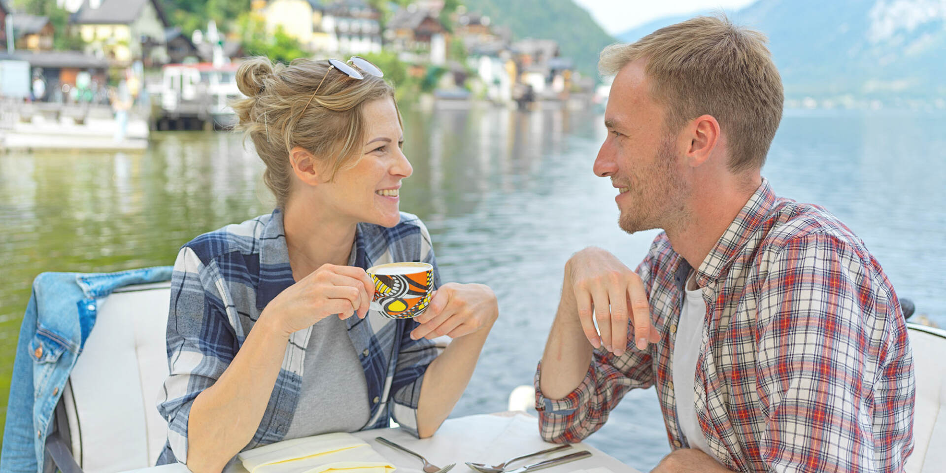 Hallstatt - Paar sitzt im Restaurant am See und trinkt Kaffee - Hallstatt Tour mit Salzburg Panorama Tours