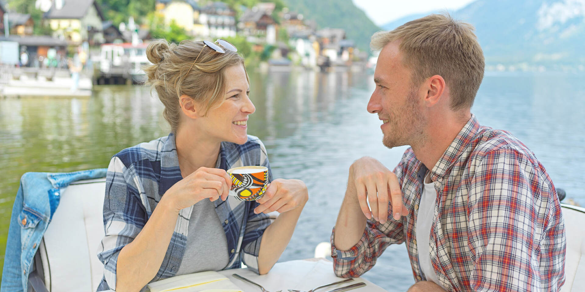 Hallstatt - Paar sitzt im Restaurant am See und trinkt Kaffee - Hallstatt Tour mit Salzburg Panorama Tours