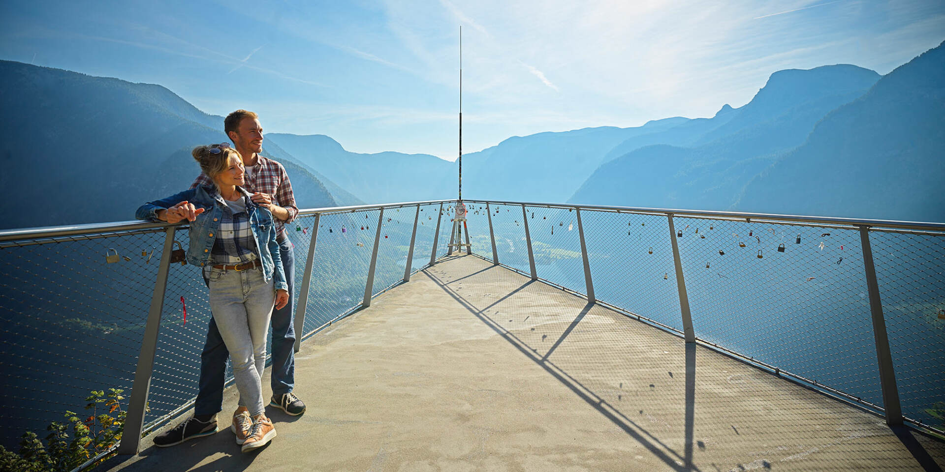 Hallstatt - Couple stands at the Skywalk World Heritage View with panoramic view of the mountains - Hallstatt Tour with Salzburg Panorama Tours