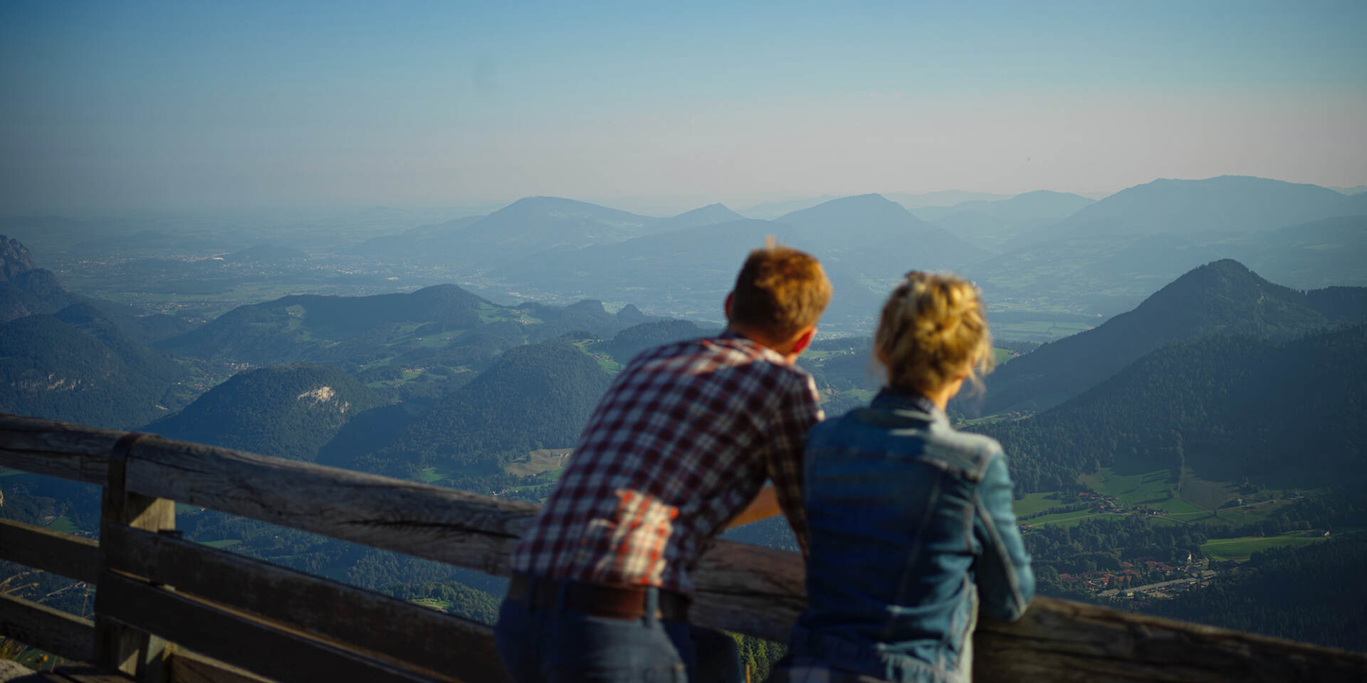 Visitors of the Eagles Nest lean on railings and marvel at the Bavarian Alps - Eagles Nest Tour with Salzburg Panorama Tours