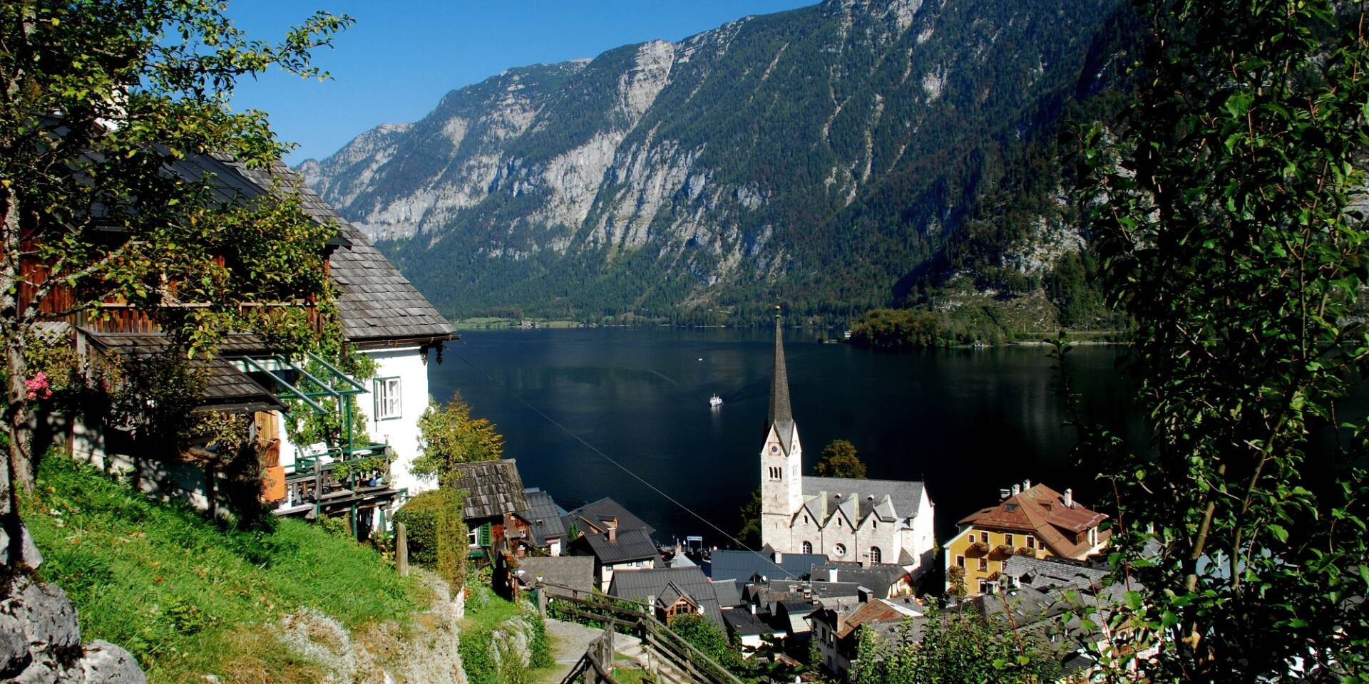 Hallstatt in summer with a view of the church from the footpath