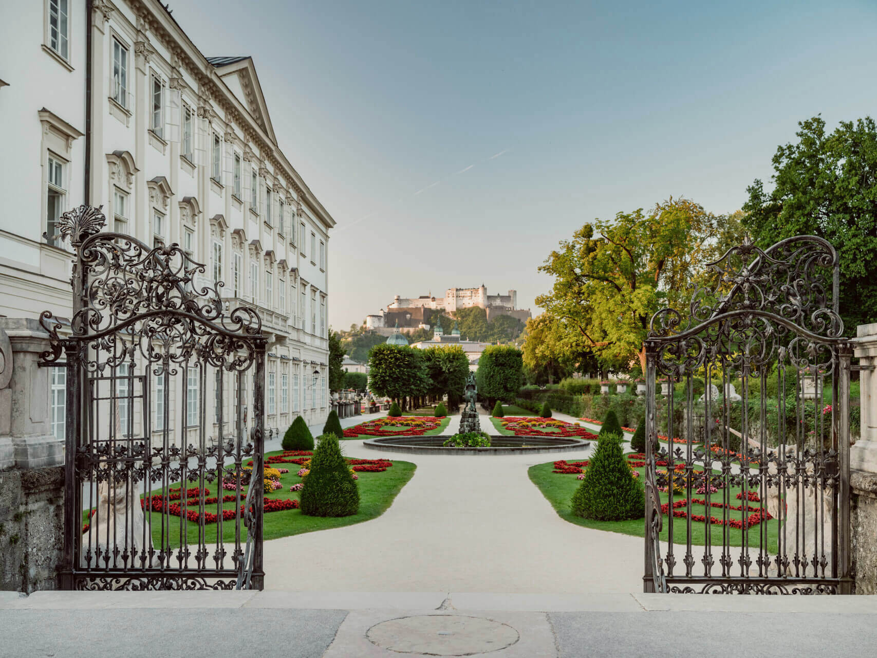 Hohensalzburg Fortress towers over Salzburg's Mirabell Gardens in the background, a key location from The Sound of Music. © Tourismus Salzburg GmbH / Patrick Langwallner