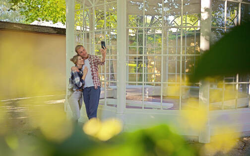 Couple posing in front of the Sound of Music gazebo at Hellbrunn on the Sound of Music Tour by Salzburg Panorama Tours